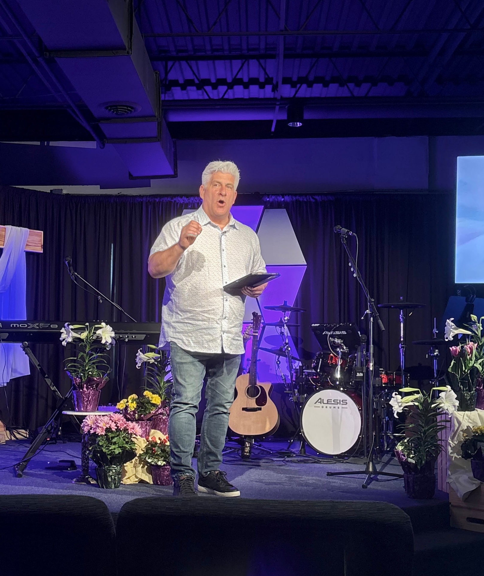 Pastor Craig Jarvis teaching from the stage at Anchor Point Church.